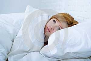 Young woman lying in bed sick unable to sleep suffering depress