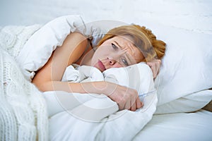 Young woman lying in bed sick unable to sleep suffering depress
