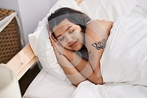 Young woman lying on bed sleeping at bedroom