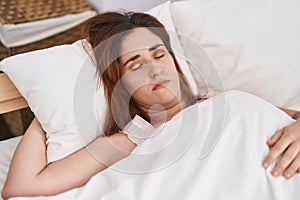 Young woman lying on bed sleeping at bedroom