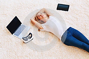 Young woman lying down on carpet