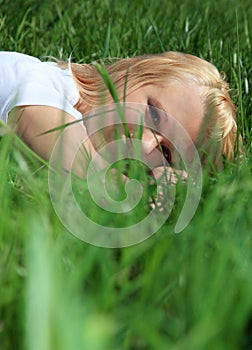 Young woman lying in green grass