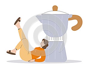 A young woman lying on the ground and leaning on a huge coffee pot or coffee maker. Beautiful funny coffee drinker girl