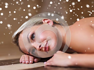 Young woman lying on hammam table in turkish bath