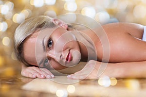 Young woman lying on hammam table in turkish bath