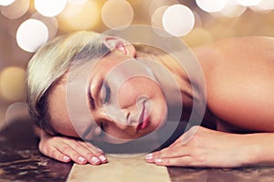 Young woman lying on hammam table in turkish bath