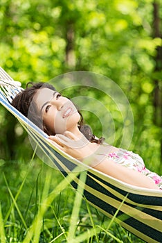 Young woman lying in a hammock