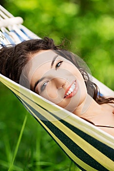 Young woman lying in a hammock