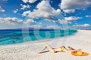 A young woman lying at Sahara beach of Naxos island, Greece