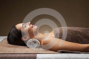 Young woman lying at spa or massage parlor