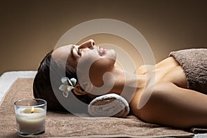 Young woman lying at spa or massage parlor