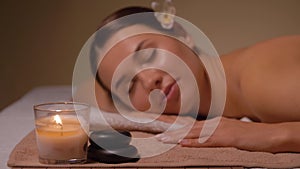 Young woman lying at spa or massage parlor