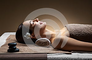 Young woman lying at spa or massage parlor