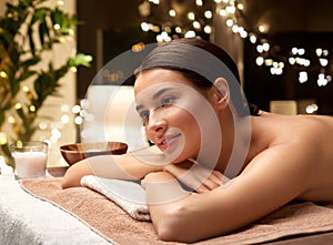 young woman lying at spa or massage parlor