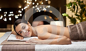 young woman lying at spa or massage parlor