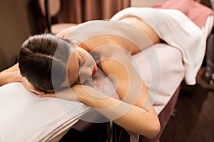 Young woman lying at spa or massage parlor