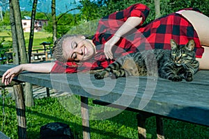 Young woman lying on a table with her cat