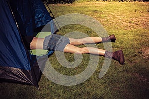 Young woman lying in a tent