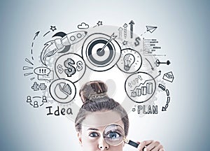 Young woman with magnifying glass, business idea