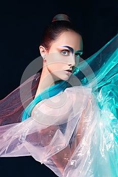 Young woman,make-up, blue hair in plastic