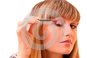 Young woman make up her eyebrow isolated