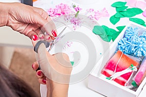 Young woman makes artificial flowers