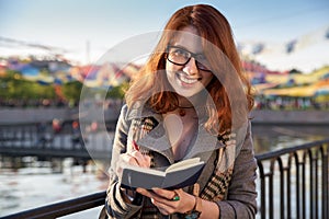 Young woman makes notes in her diary. Woman student write down new information and do a writing task.