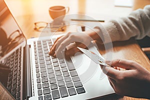 A young woman makes an online payment for a purchase.