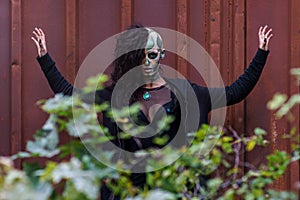 Young woman with makeup of green skull for halloween