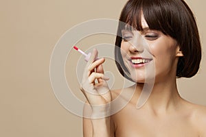 young woman makeup lipstick in hand model posing close-up Lifestyle