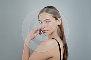 Young woman without makeup on white background, natural beauty. Skincare and facial treatment concept