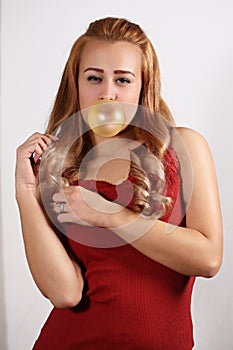 Young woman making a big bubble