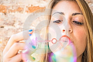 Young woman making bubbles