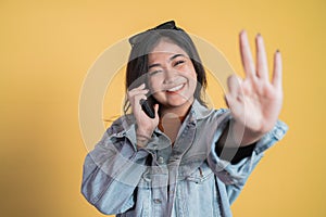 Young woman making a call with ok hand gesture