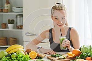 Young woman making detox smoothie at home photo