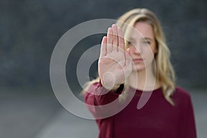 Young woman making a halt gesture