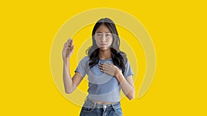 Young woman making hand sign to stop behavior or gesture that suggests unethical and illegal behavior