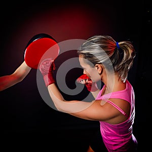 Young woman making a hard punch during training
