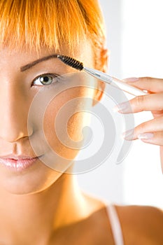 Young woman making her makeup