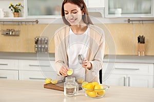 Young woman making lemon water