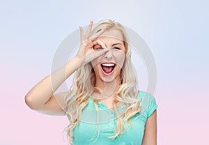 Young woman making ok hand gesture