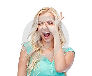 Young woman making ok hand gesture