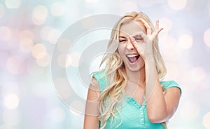 Young woman making ok hand gesture