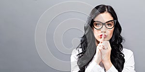 Young woman making a quiet gesture