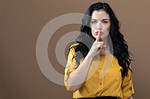 Young woman making a quiet gesture