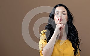 Young woman making a quiet gesture