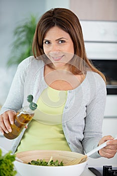 young woman making salad