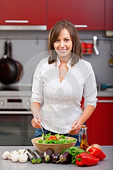 Young woman making salad