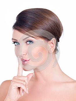 Young woman making a shushing gesture photo