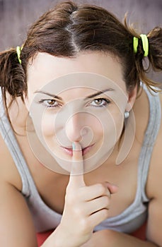 Young woman making silence gesture